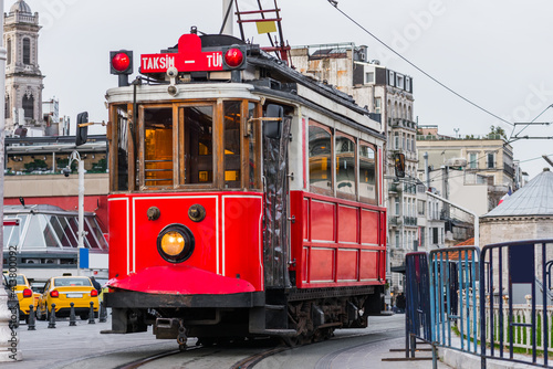 Nostalgic red tram in Taksim Square. Istiklal Street is a popular touristic destination in Istanbul, Turkey.  .
