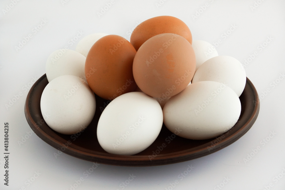 Chicken eggs on ceramic plate, isolated white background Chicken eggs on ceramic plate, isolated white background