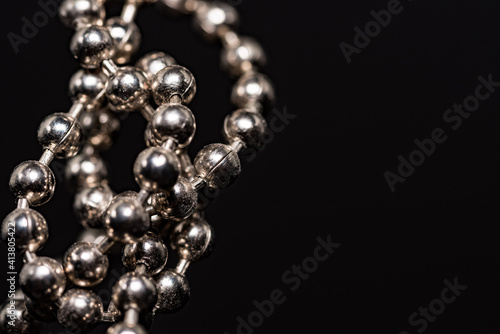 Close-up metal chain chain with shallow depth of field. Blurry perspective and conceptual background.