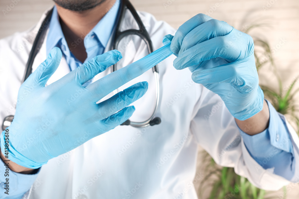 man doctor wears medical gloves, close up man doctor wears medical gloves, close up