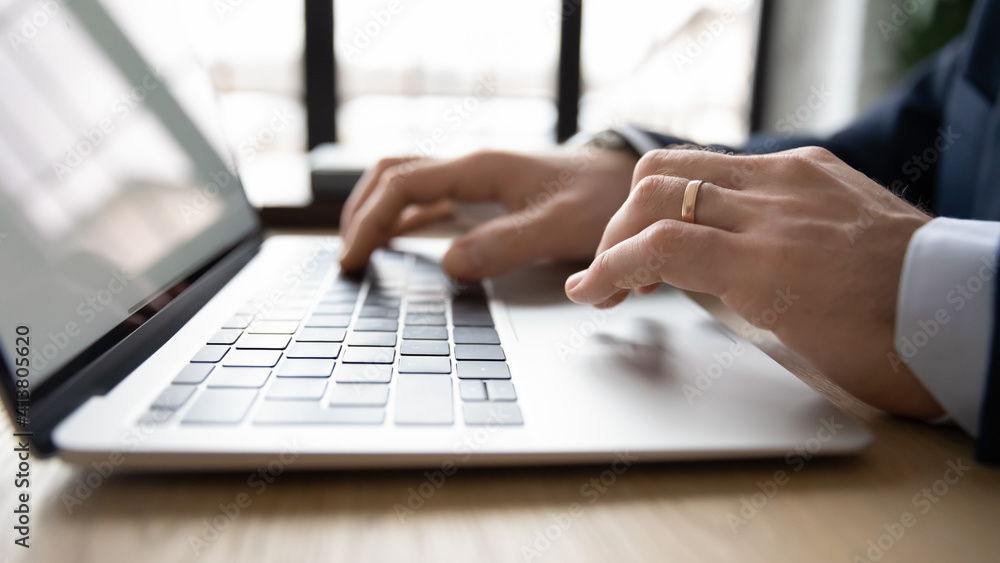 Crop close up of male CEO or employee work distant on laptop write email letter to business partner or client. Businessman use computer consult customer online on gadget in office. Technology concept.