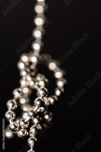 Close-up metal chain chain with shallow depth of field. Blurry perspective and conceptual background.