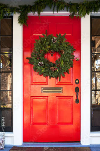 Christmas wreath hanging on red door