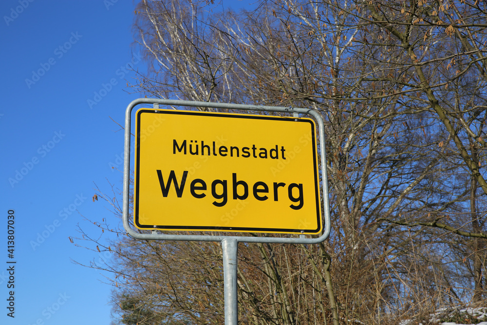 View on isolated yellow town entrance sign of Wegberg, city of mills (focus on sign)