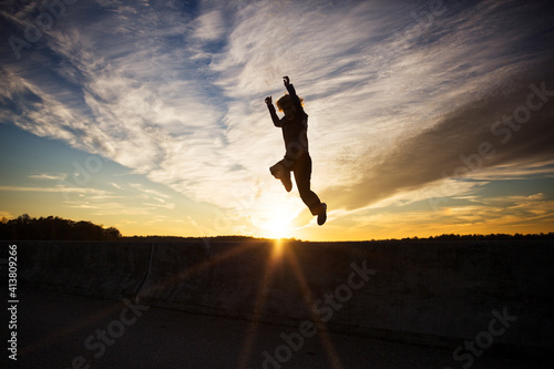 Wallpaper Mural Silhouette of boy jumping against sky at sunset Torontodigital.ca