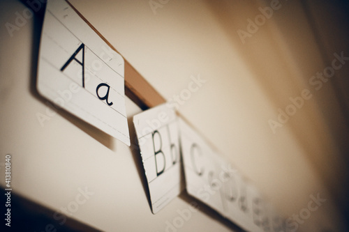 Low angle view of alphabets written on paper hanging in classroom photo