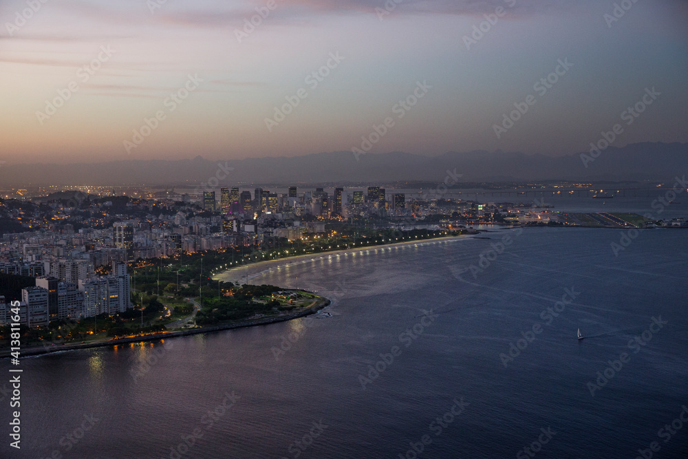 Scenic view of cityscape and sea against sky during sunset Scenic view of cityscape and sea against sky during sunset