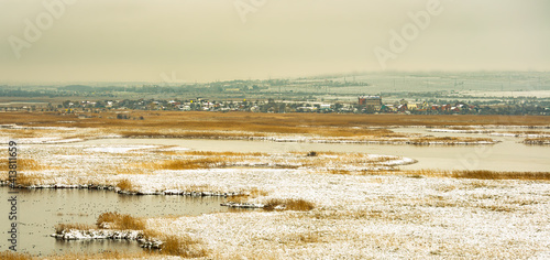 winter steppen landscape with the urban horizon photo