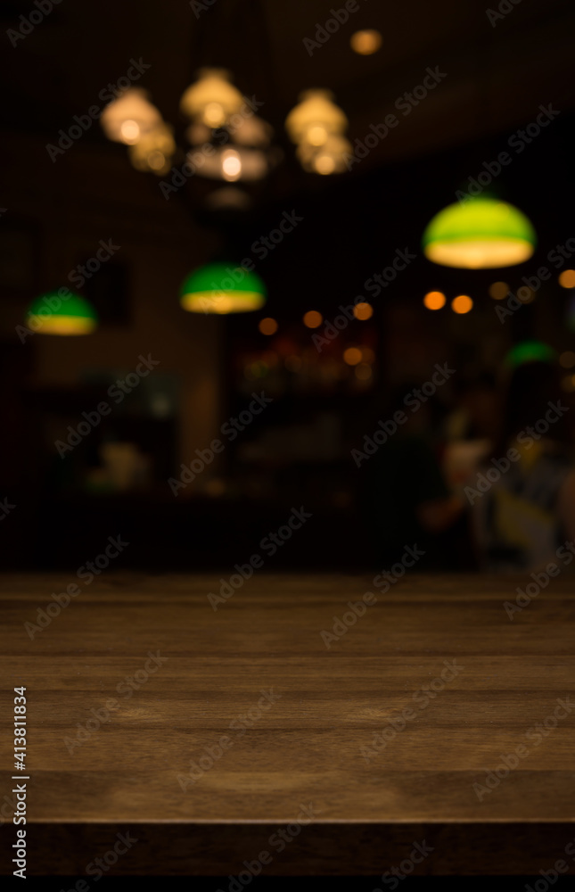 Empty wooden top table on blur restaurant background.