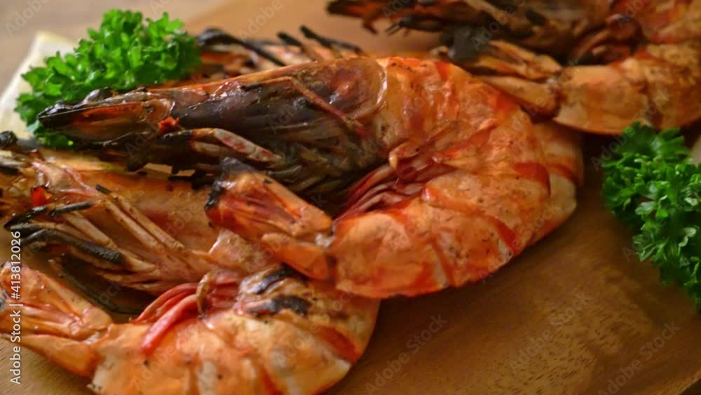 grilled tiger prawns or shrimps with lemon on wood board grilled tiger prawns or shrimps with lemon on wood board