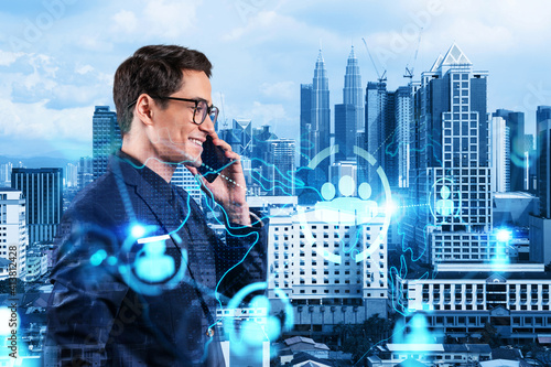 Canvas Print A young handsome eastern businessman processing conference call to develop social media marketing strategy to achieve business goals