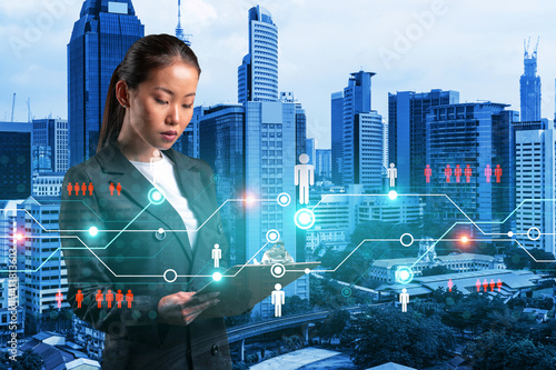 Canvas Print Attractive Asian HR director at international company is looking into personal organizer to plan business meeting to recruit highly qualified specialists