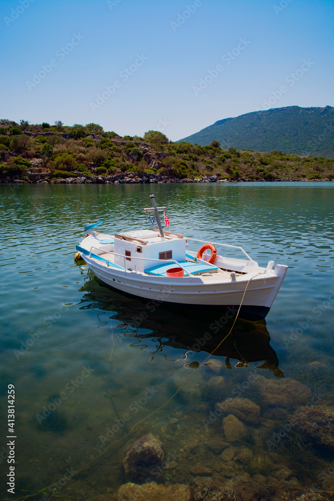 Empty boat moored in lake against clear sky Empty boat moored in lake against clear sky