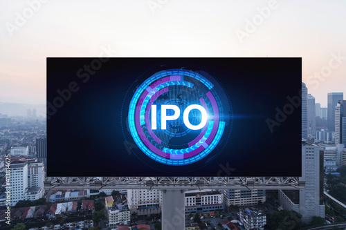 IPO icon hologram on road billboard over sunset panorama city view of Kuala Lumpur. KL is the hub of initial public offering in Malaysia, Asia. The concept of exceeding business opportunities.