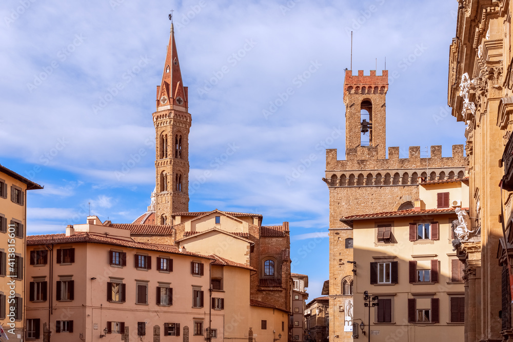 Medieval square (Piazza di San Firenze) with bell towers in the historical centre of Florence, Italy