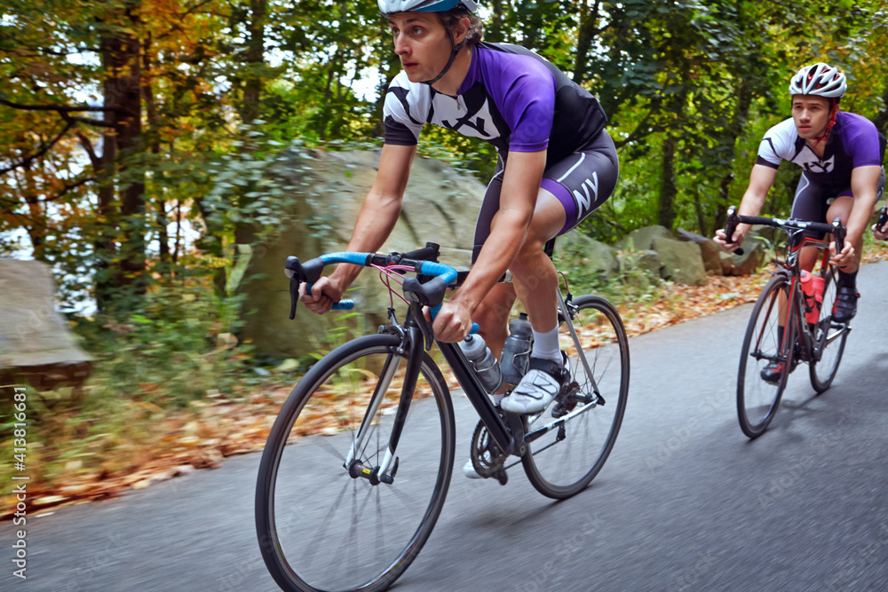Male cyclists riding bicycles on road Male cyclists riding bicycles on road