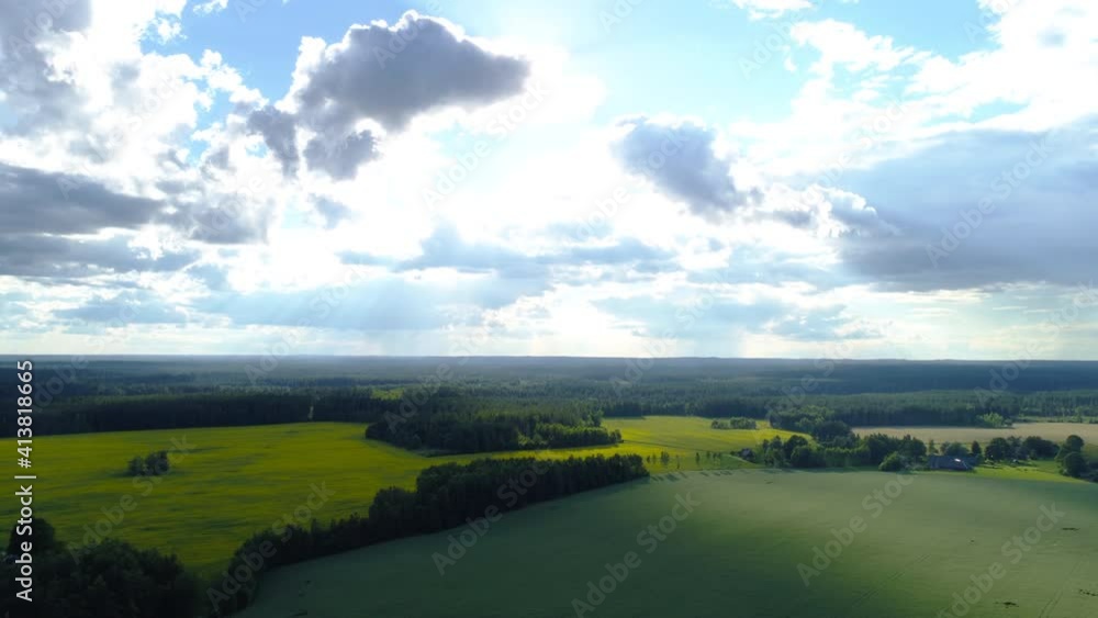 Dronelapse of beautiful countryside landscape with cultivated fields, green trees and blue sky gleaming sunshine horizon, timelapse up motion Dronelapse of beautiful countryside landscape with cultivated fields, green trees and blue sky gleaming sunshine horizon, timelapse up motion