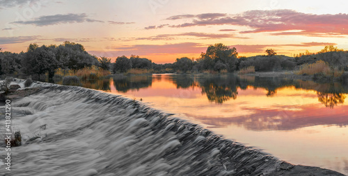 Beautiful view of the dam on the river at sunset photo