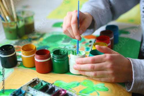 Childrens hands with brush and paints