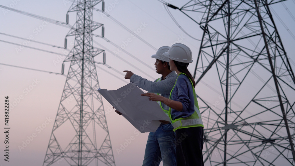 Two specialist electrical engineer working near to High voltage tower. Two specialist electrical engineer working near to High voltage tower.