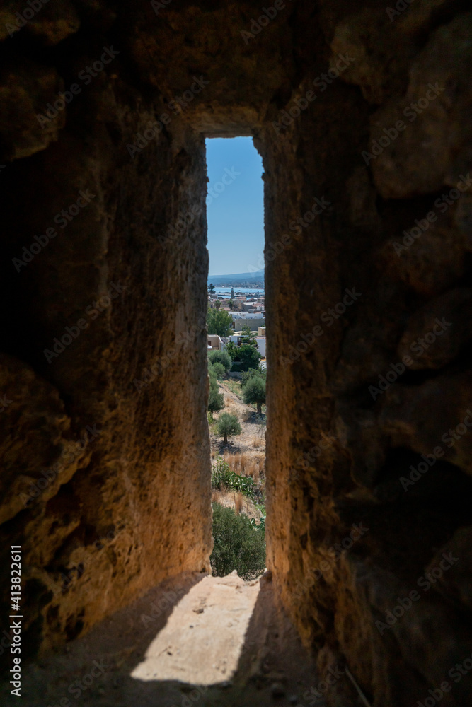Ruins of old town in Rethymno, Crete, Greece. It largest castle in central Europe. View from the walls window. Port in background