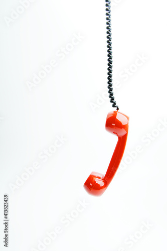 Classic red phone on white background. © Akmalism