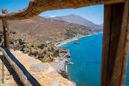 Famous Preveli palm beach on Crete island, Greece. Wooden barriers in foreground 