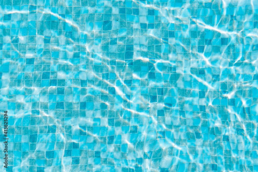 Water surface of swimming pool with sun reflection