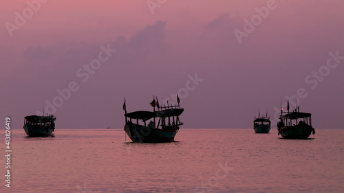 Koh Rong Island, Cambodia at Sunrise. strong vibrant Colors, Boats and Ocean photo