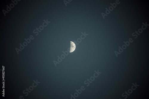 Low angle scenic view of half moon in clear sky at night photo