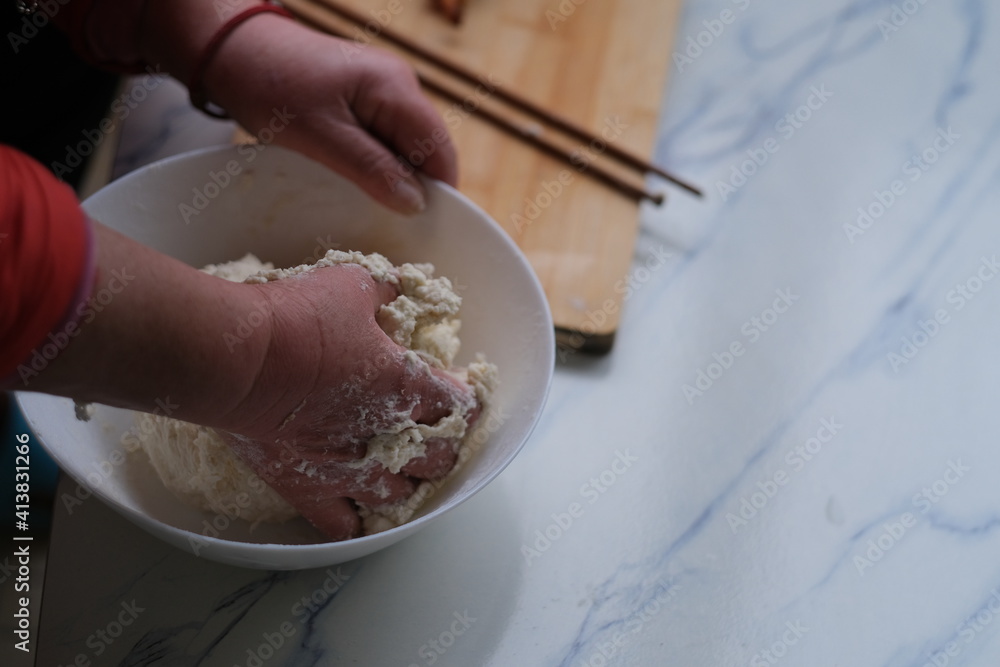 high angle view of hand knead dough on table. Making traditional Chinese food concept