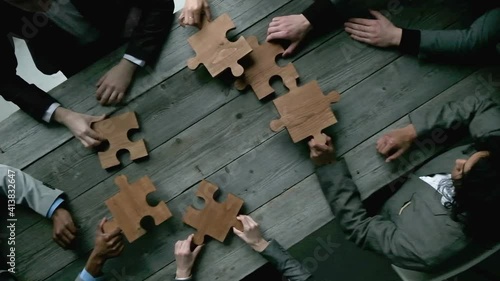Business teamwork with puzzle finishing project cooperation unity concept