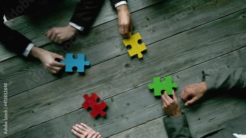Business teamwork with color puzzle of four pieces cooperation unity concept