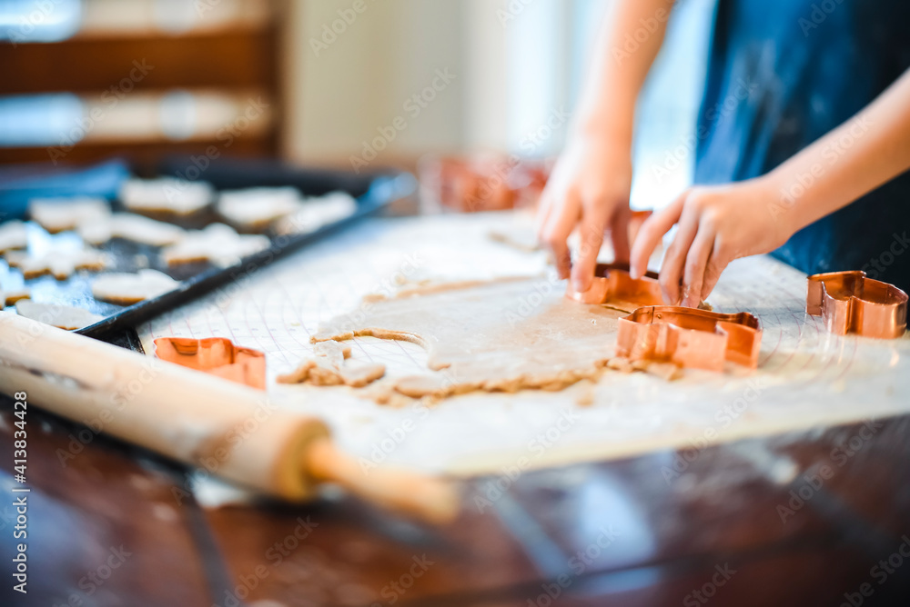 Close up of child's hands using cookie cutters on cookie dough. Close up of child's hands using cookie cutters on cookie dough.