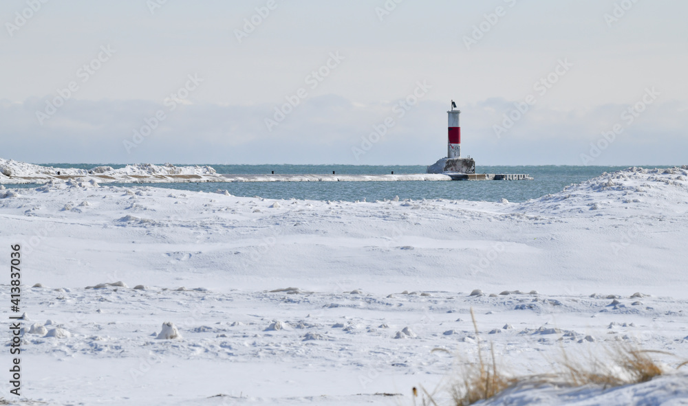 snow covered winter lake shore lighthouse
