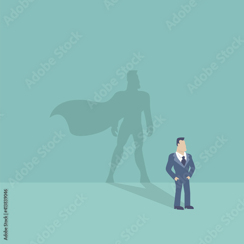 Businessman and shadow in the form of a hero with a cloak.