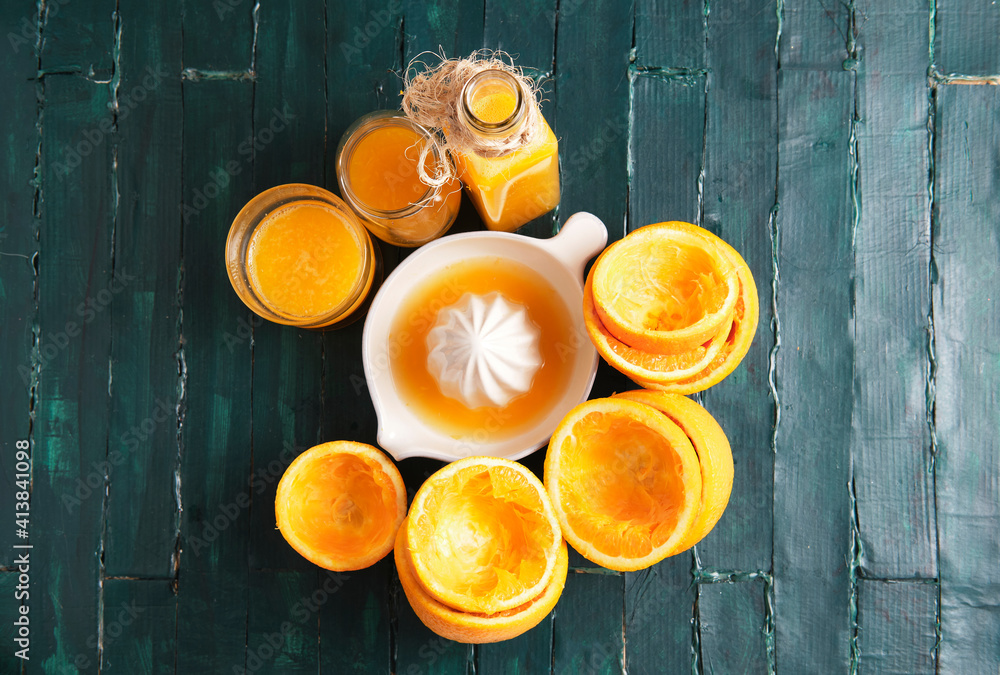 still life on a green wooden base of an orange squeezer with orange ju still life on a green wooden base of an orange squeezer with orange ju