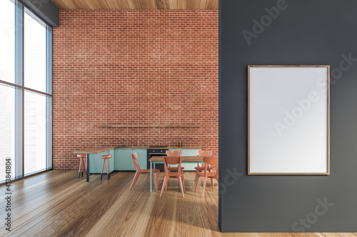 Modern kitchen interior with copy space on red brick wall, wooden countertops with a built in sink and a cooker. Mock up. Loft apartment dining room area. Front poster on grey wall. photo