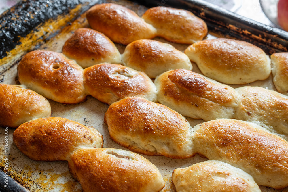 Baked homemade pies on the baking sheet