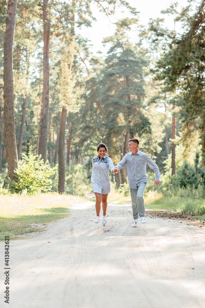 young couple in love having fun and enjoying the beautiful summer nature. woman and man, wearing in denim outfit are having date outdoors in the park. Romantic relationship. valentines day young couple in love having fun and enjoying the beautiful summer nature. woman and man, wearing in denim outfit are having date outdoors in the park. Romantic relationship. valentines day