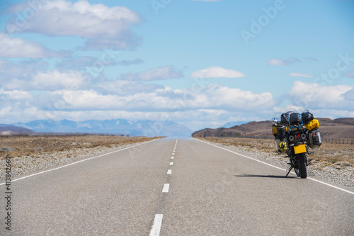 Adventure motorcycle parked at the side of highway in Argentina photo