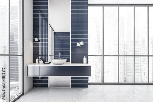 White and blue bathroom with one sink and mirror near window