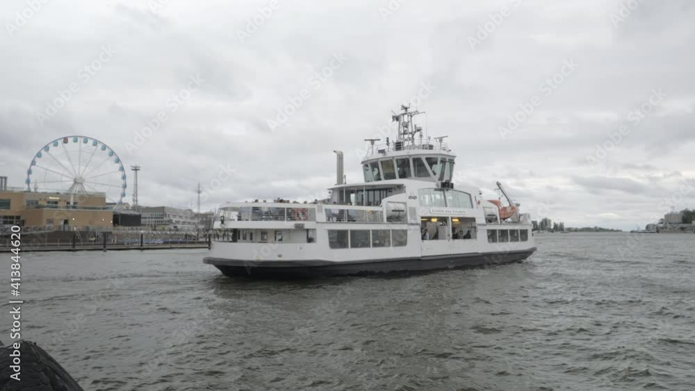 Helsinki.Finland-September 2.2020: A ferry departing the harbor port in island Suomenlinna in Helsinki Finland with the passengers inside Helsinki.Finland-September 2.2020: A ferry departing the harbor port in island Suomenlinna in Helsinki Finland with the passengers inside