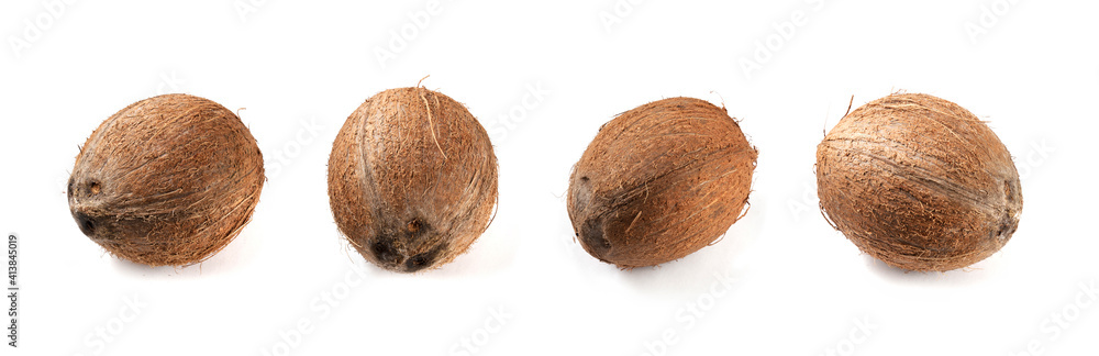 Four coconuts on a white background. Panorama. 