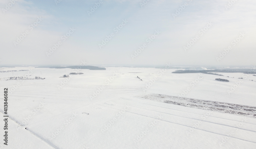 Top view of rural landscape with snow covered field in winter