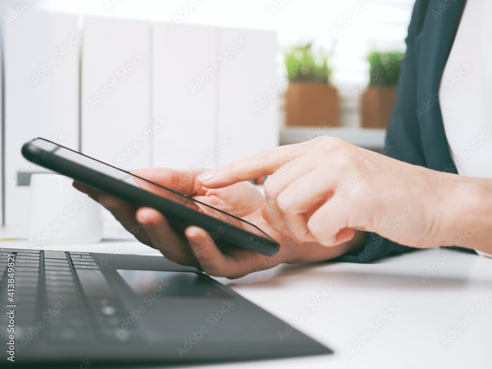young woman typing on smartphone. Home office, online business marketing or learning concept. Online shopping, booking and banking background with copy space. tax return