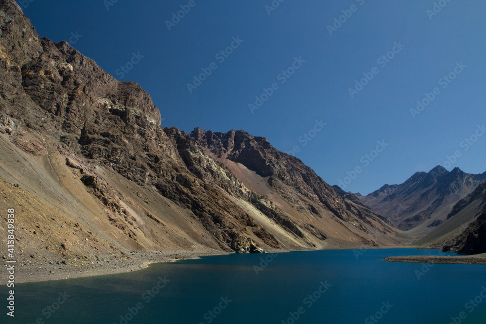 Alpine landscape. The glacier water lake in the cordillera in a summer sunny day. View of the turquoise color lake called Inca Lagoon high in the Andes mountain range in Portillo, Chile.