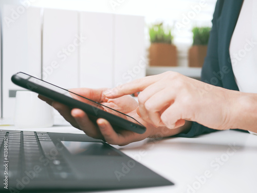 Obraz na płótnie young woman typing on smartphone. Home office, online business marketing or learning concept. Online shopping, booking and banking background with copy space. tax return w salonie