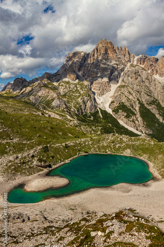 View of the Dolomites mountains with a colorful turquoise alpine lake