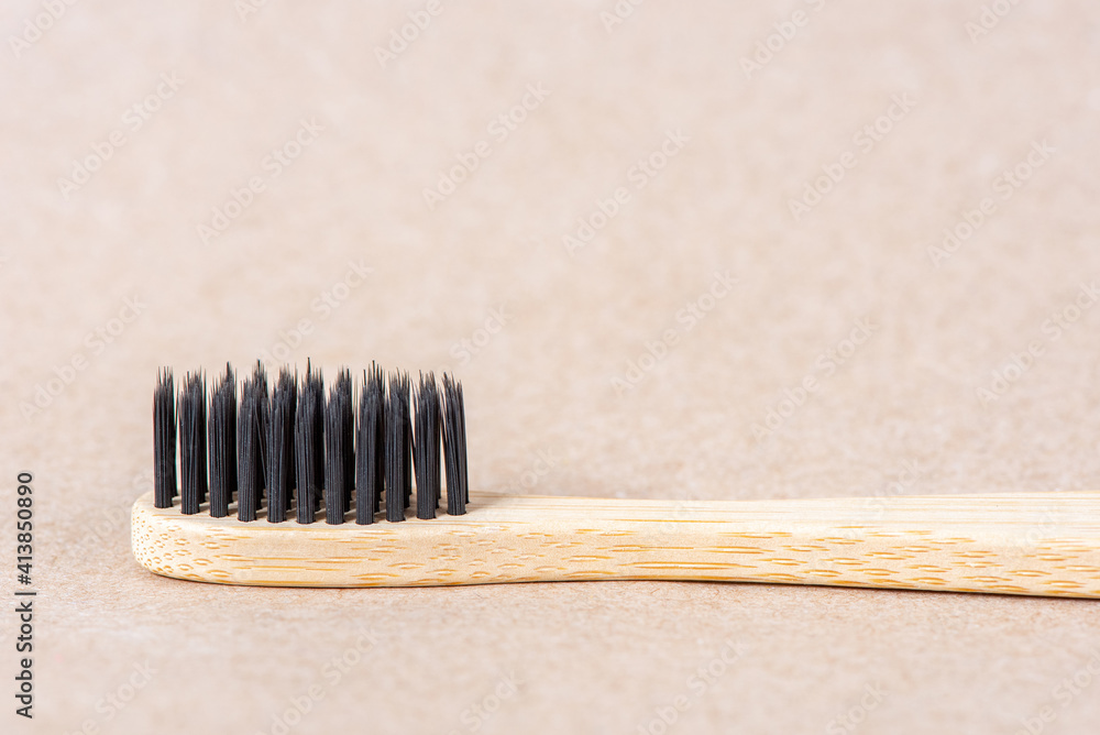 Eco friendly bamboo toothbrush close up on brown background. Zero waste concept Eco friendly bamboo toothbrush close up on brown background. Zero waste concept